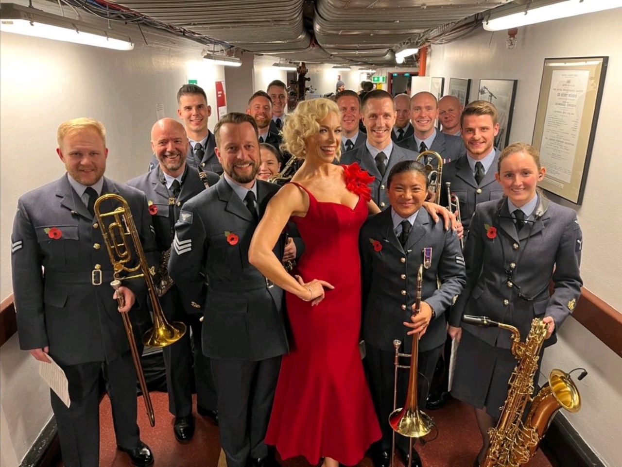 Image shows RAF Musicians with lady in a red dress.
